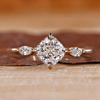 Cushion cut diamond ring marquise side stones three stone.