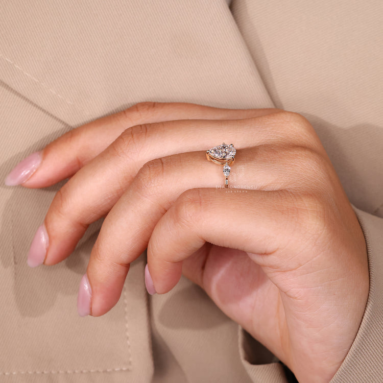 Elegant pear cut diamond ring with tapered band.