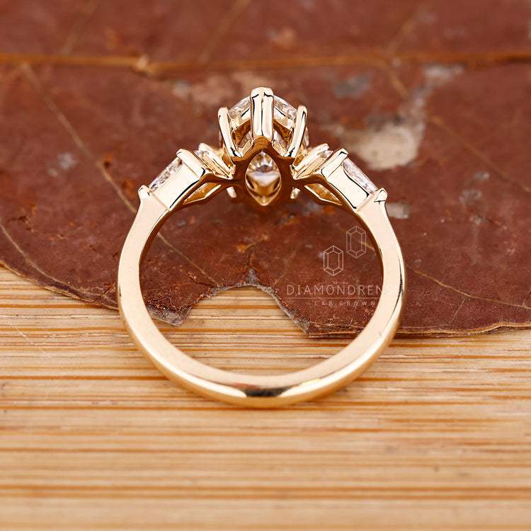 Three stone ring with claw prongs and side stones.