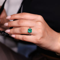 Emerald gemstone ring tapered shank open gallery set.