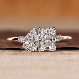 Pear and radiant cut ring toi et moi split shank style.