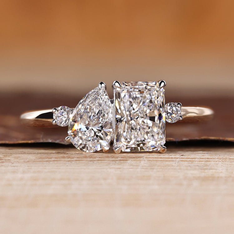 Pear and radiant cut ring toi et moi split shank style.
