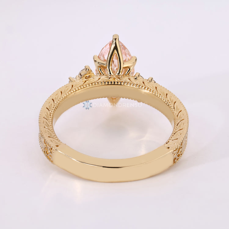 Handmade pink diamond marquise ring with cluster setting.