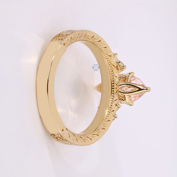Marquise diamond ring with pink centre stone and side stones.