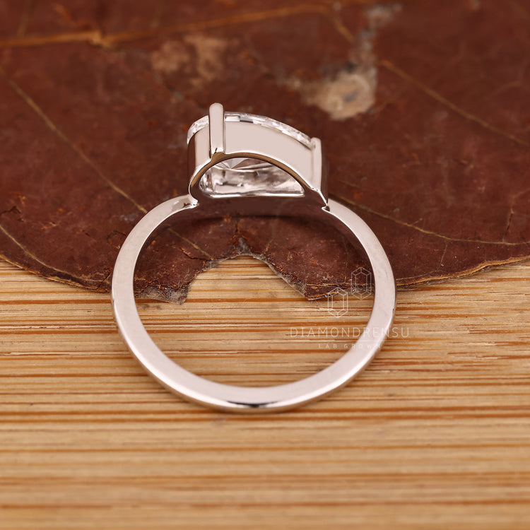 East to west set pear diamond solitaire ring.