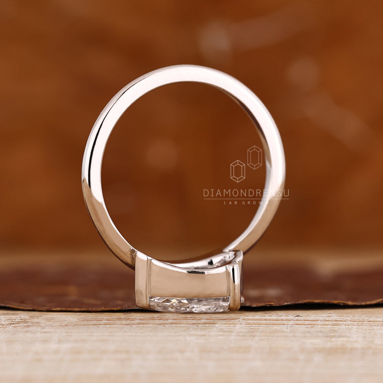 Minimal pear diamond ring in solitaire setting.