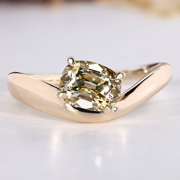 Old mine cushion cut diamond ring with east to west setting.
