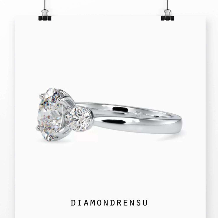 Three stone diamond ring with oval-cut diamonds for a dazzling effect.