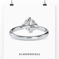 White Gold ring with round diamond and unique bypass setting.