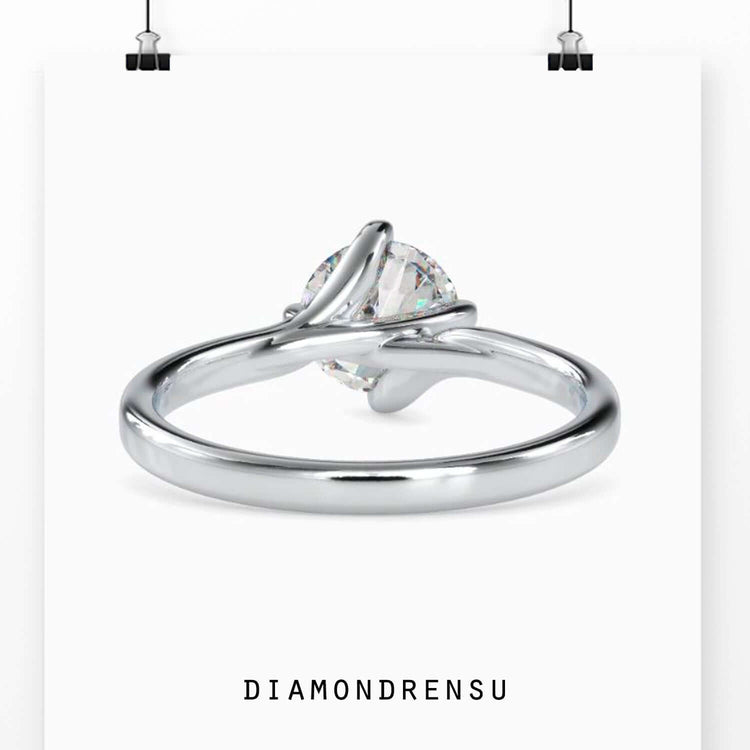 White Gold ring with round diamond and unique bypass setting.