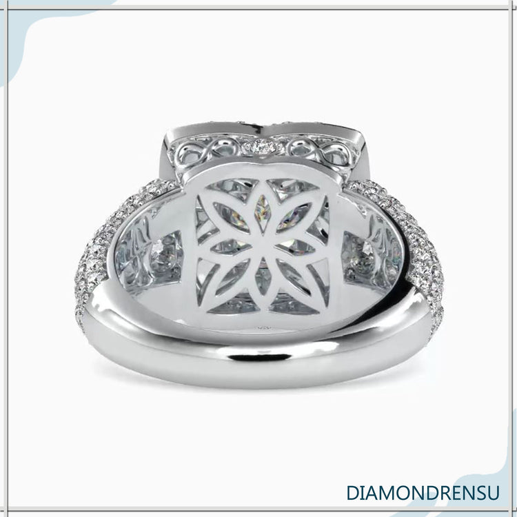 Side stone engagement ring featuring a princess cut diamond and brilliant side stones.