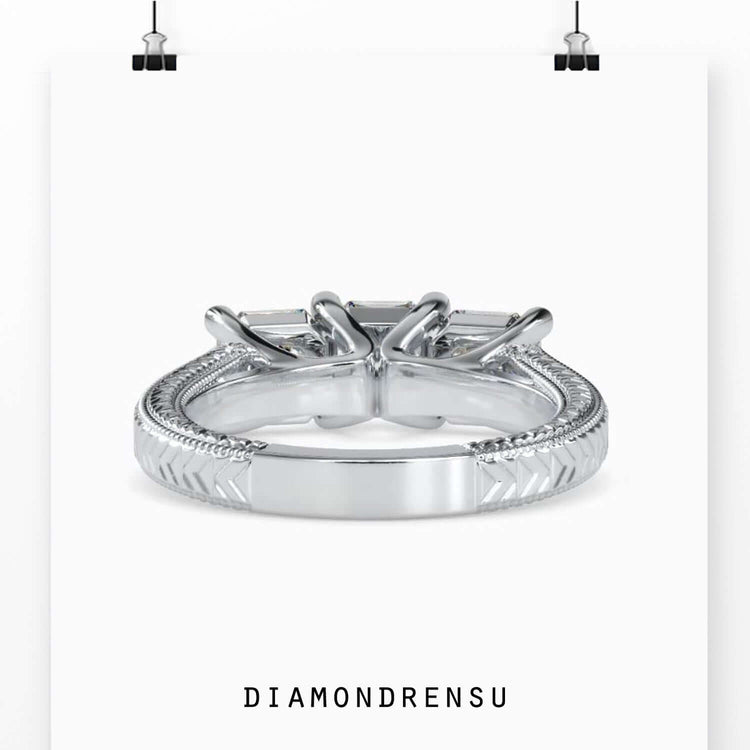 Three stone emerald cut diamond ring in 3 stone trellis ring setting.