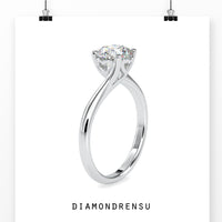 Round brilliant cut diamond ring with a chic bypass setting.