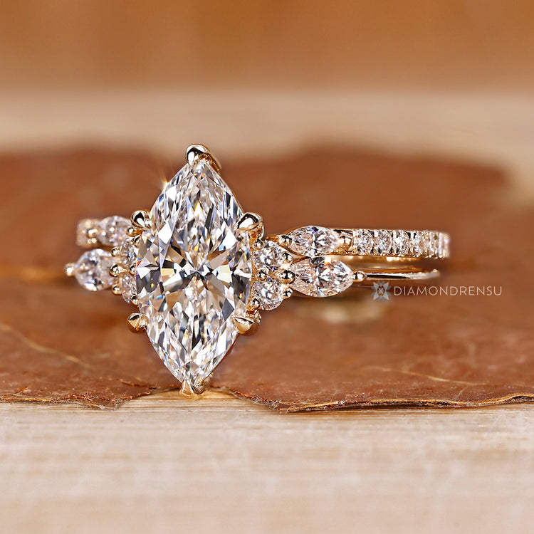 Lab grown marquise ring with round diamond side stones.