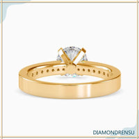Engagement ring with pave accents enhancing the beauty of the diamond.