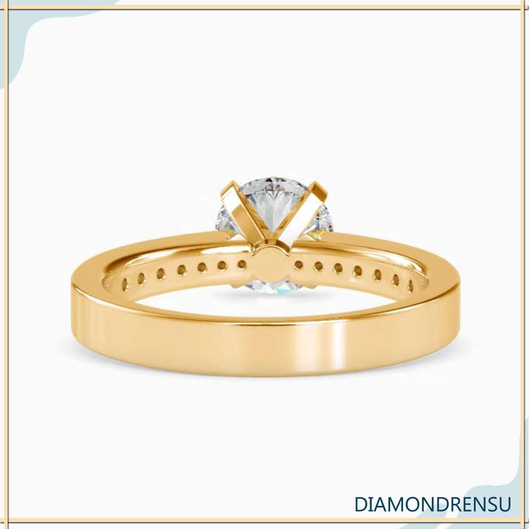 Engagement ring with pave accents enhancing the beauty of the diamond.