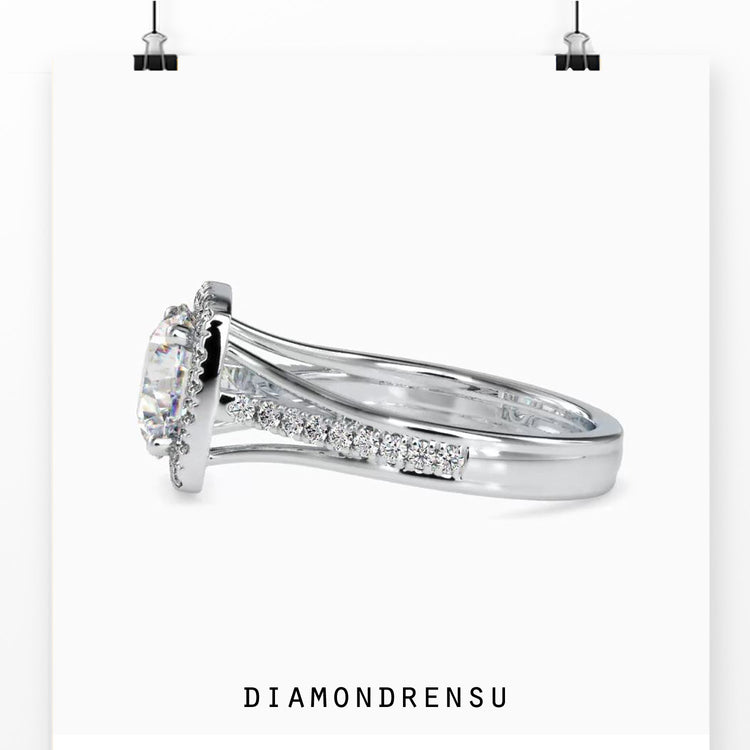 Round diamond solitaire engagement ring with a split shank setting.