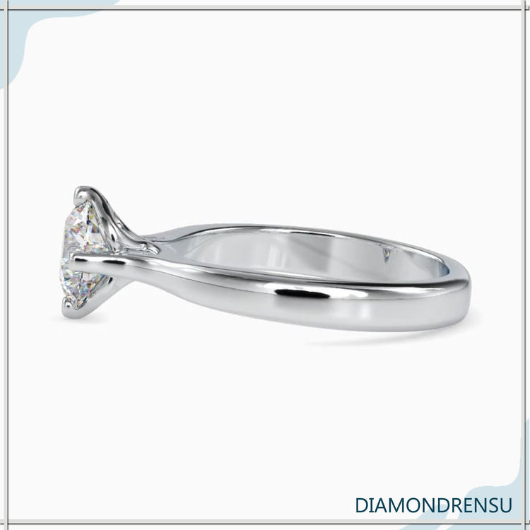 Engagement ring with side stones in a classic round cut diamond style.