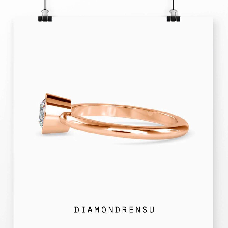 Timeless single diamond engagement ring with a secure bezel setting for elegance.