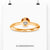 Elegant gold solitaire engagement ring featuring a round brilliant cut diamond.