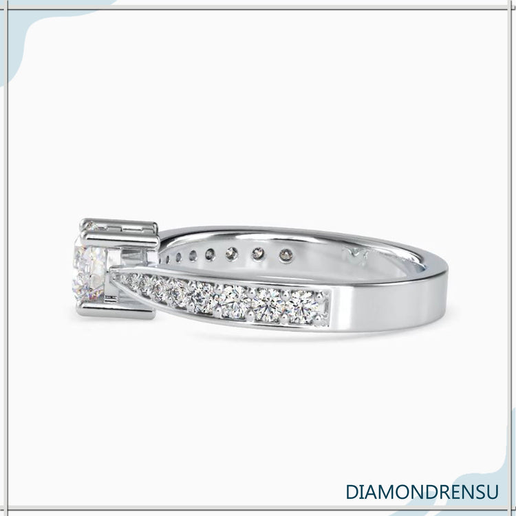 Unique diamond engagement ring with a round cut diamond and a pave diamond ring setting.