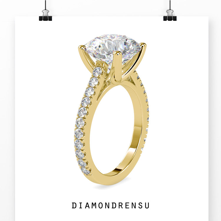 Handmade jewelry featuring a round diamond engagement ring in a cathedral setting with pave details.