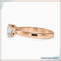 Round solitaire engagement ring with cathedral setting.