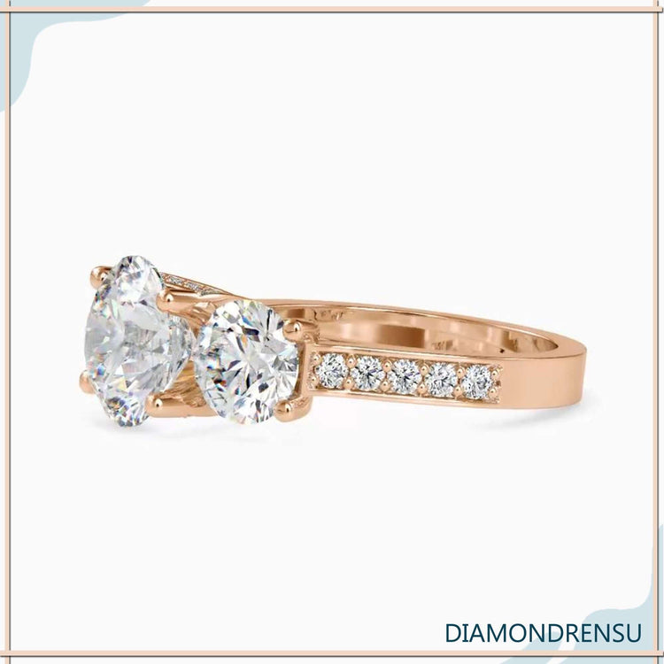 Round engagement ring with side stones in rose gold, white gold, or yellow gold.