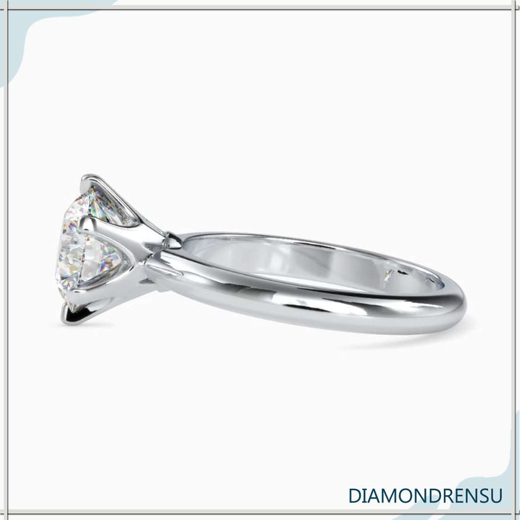 Round solitaire gold engagement ring with a radiant, classic design.
