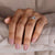 A woman's hand adorned with a unique and captivating diamond ring.