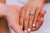 A lady with Petite Fingers wearing a diamond ring