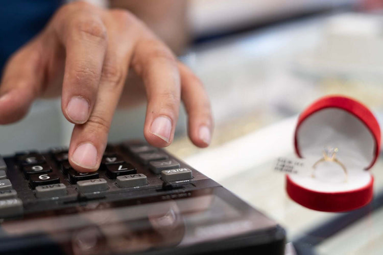 A man calculating price of a diamond