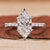 Hidden halo engagement ring with Dutch marquise diamond engagement ring style.

