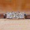 Princess cut diamond ring set in a classic white gold band.

