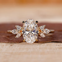 Hidden halo engagement ring with oval cut diamond in a claw prong setting yellow gold ring.
