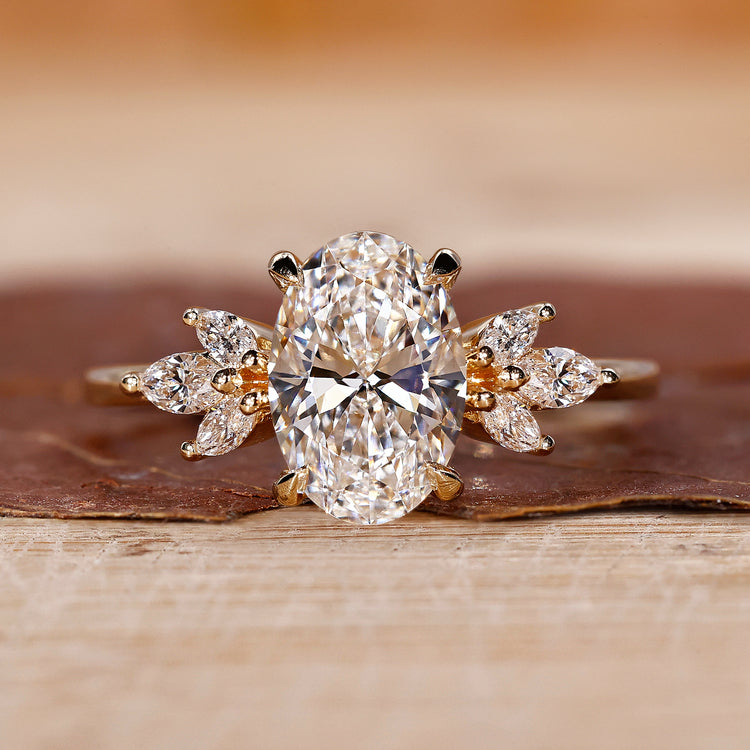 Hidden halo engagement ring with oval cut diamond in a claw prong setting yellow gold ring.
