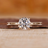 Yellow gold engagement ring with round cut diamond ring.
