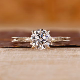 Yellow gold engagement ring with round cut diamond ring.
