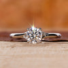 Round brilliant cut diamond ring with a split shank design.
