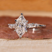 Pave setting ring with marquise and round side stone.
