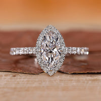 Halo diamond ring with round cut center stone.
