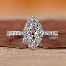 Halo diamond ring with round cut center stone.
