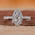 Halo diamond ring with round cut center stone.
