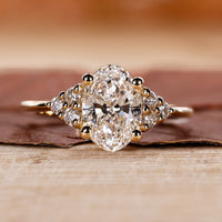 Oval Cut Diamond Engagement Ring with round cut side stones ring.
