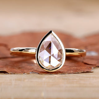 Rose cut diamond ring with pear solitaire design.
