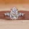 5 stone diamond ring featuring pear and round diamonds in white gold.
