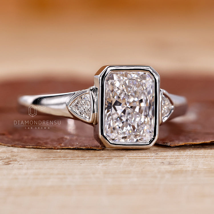 Trillion cut side stone fits radiant cut engagement ring.
