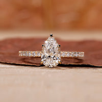Pear diamond engagement ring with hidden halo setting