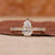 Pear diamond engagement ring with hidden halo setting