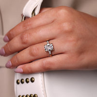 Three stone cushion cut ring with tapered baguette sides.
